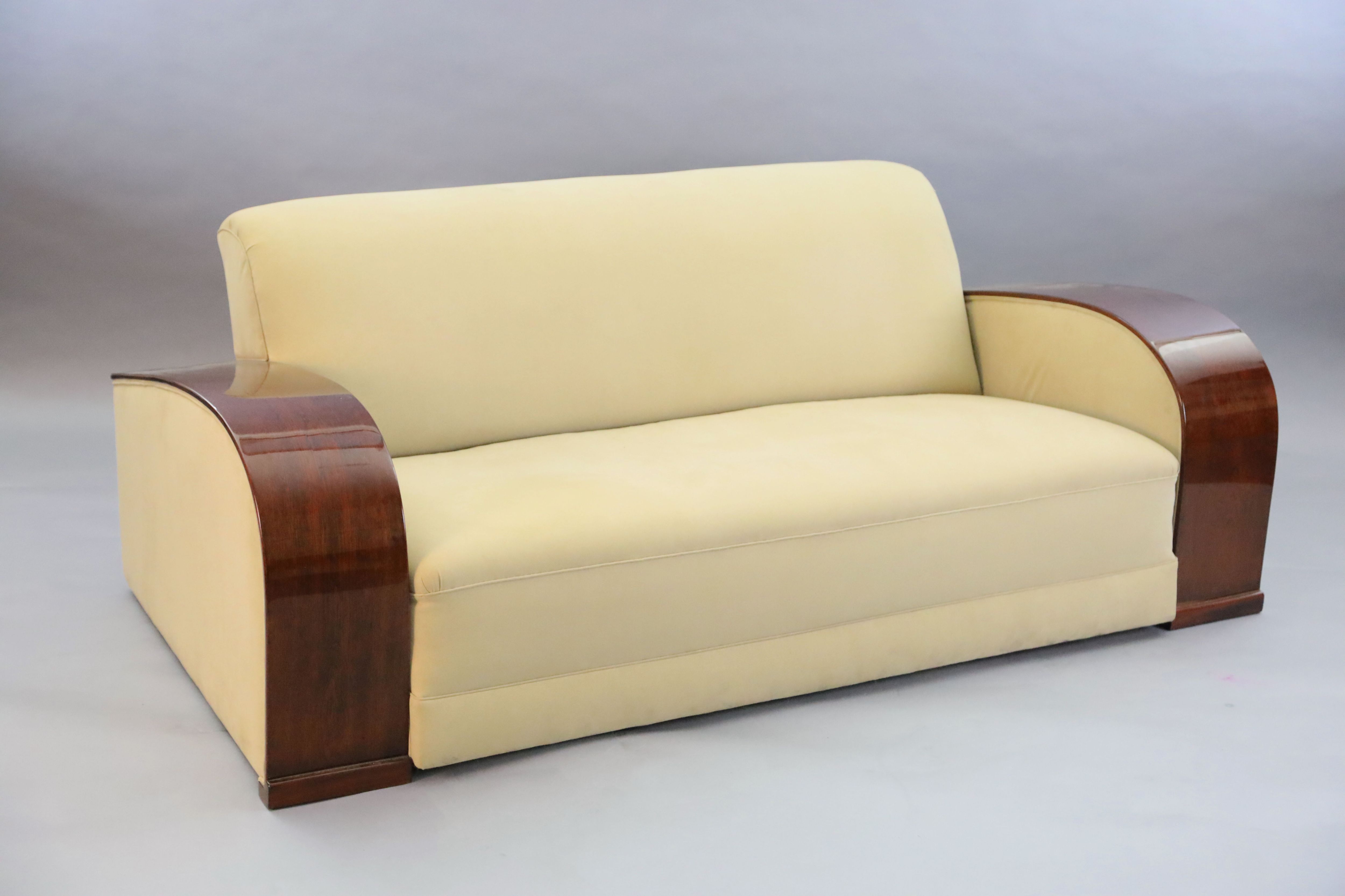 An Art Deco style mahogany and suede three piece suite, settee W.6ft 6in. D.3ft 4in. H.2ft 6in.